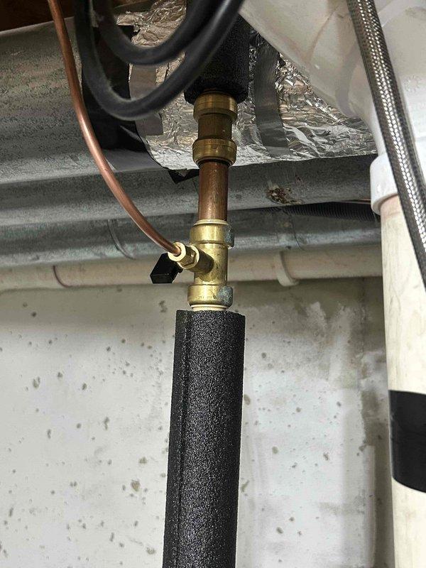 Responded to callback for possible water heater leak following previous furnace and air conditioning installation. Inspected plumbing connections, copper piping, brass fittings, and shut-off valve assembly associated with the water heater. Verified all compression fittings, valve connections, and insulated piping for signs of moisture or active leaks. Documented installation with photos showing proper pipe insulation, brass fitting assembly, flexible supply lines, and valve configuration. All connections found secure with no visible leakage or deterioration at time of inspection.
