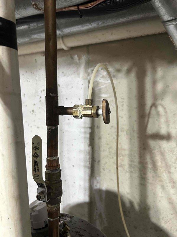 Responded to callback for possible water heater leak following previous furnace and air conditioning installation. Inspected plumbing connections, copper piping, brass fittings, and shut-off valve assembly associated with the water heater. Verified all compression fittings, valve connections, and insulated piping for signs of moisture or active leaks. Documented installation with photos showing proper pipe insulation, brass fitting assembly, flexible supply lines, and valve configuration. All connections found secure with no visible leakage or deterioration at time of inspection.