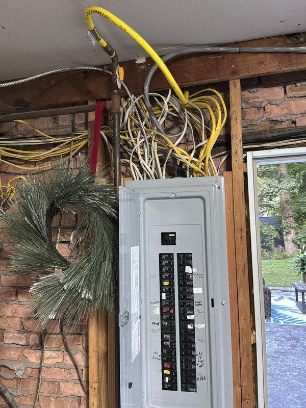 Completed electrical site assessment for new whole home Kohler generator installation. Evaluated existing main electrical panel configuration, circuit breaker layout, and available capacity to determine proper integration point for automatic transfer switch. Documented current electrical infrastructure including main service panel location in garage area, existing circuit distribution, and wire routing pathways to establish generator placement requirements and connection specifications for upcoming installation.