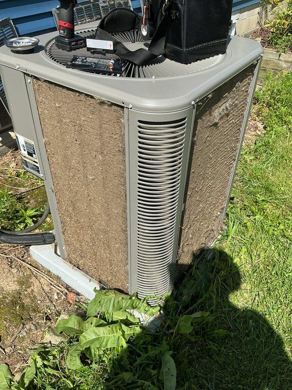 Responded to no cooling call for 3-year-old residential air conditioning system with outdoor condenser located in backyard and air handler in basement. Upon arrival, performed diagnostic evaluation of system that would not turn on. Inspected outdoor condenser unit and found significant dirt and debris accumulation on coil fins and protective grilles, restricting airflow. Tested electrical components including capacitor, contactor, and fan motor. Identified failed component preventing system operation. Replaced defective part under manufacturer parts warranty. Cleaned condenser coil surfaces to restore proper airflow and heat transfer efficiency. Cycled system through complete startup sequence, verified proper amperage draw on compressor and condenser fan motor, and confirmed adequate temperature split across evaporator coil. System restored to full operational status with normal cooling performance.