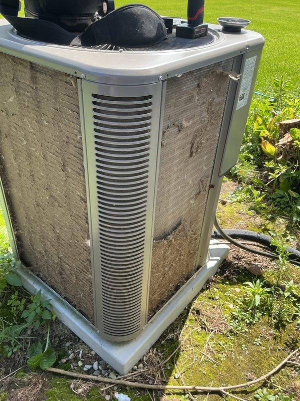 Responded to no cooling call for 3-year-old residential air conditioning system with outdoor condenser located in backyard and air handler in basement. Upon arrival, performed diagnostic evaluation of system that would not turn on. Inspected outdoor condenser unit and found significant dirt and debris accumulation on coil fins and protective grilles, restricting airflow. Tested electrical components including capacitor, contactor, and fan motor. Identified failed component preventing system operation. Replaced defective part under manufacturer parts warranty. Cleaned condenser coil surfaces to restore proper airflow and heat transfer efficiency. Cycled system through complete startup sequence, verified proper amperage draw on compressor and condenser fan motor, and confirmed adequate temperature split across evaporator coil. System restored to full operational status with normal cooling performance.