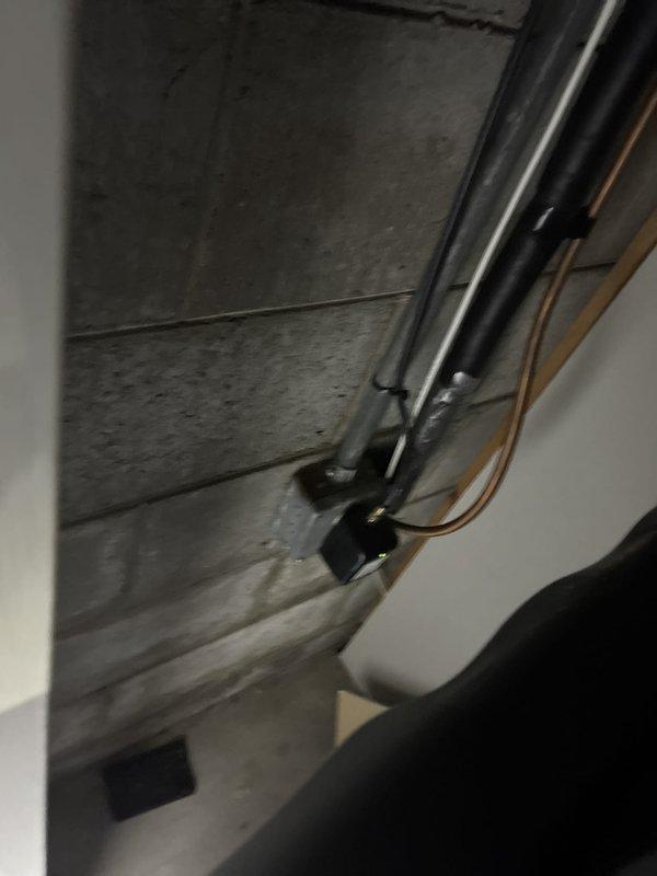 Responded to residential air conditioning service call for system evaluation and potential refrigerant concerns. Performed comprehensive assessment of outdoor condensing unit and indoor air handling components, documenting equipment condition through photographic documentation. Upon inspection, outdoor unit showed signs of age with weathered concrete pad and vegetation encroachment around base, while indoor ductwork and refrigerant lines displayed normal operational characteristics with proper mounting and connections intact.