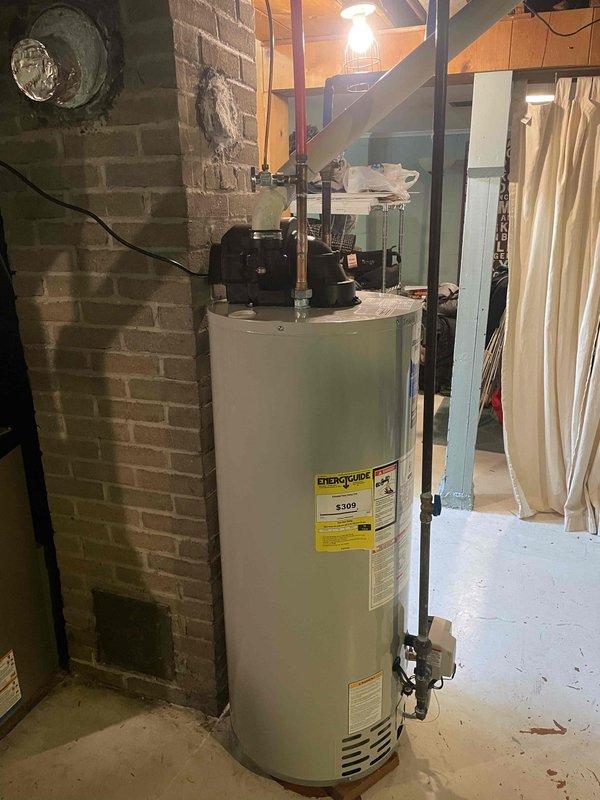 Successfully installed a new 40-gallon gas-fired tanked water heater (model RG1PV40S6N) in the basement utility area. The installation included proper venting through PVC exhaust piping that extends through the foundation wall, connection of all water supply lines, and gas line hookup. All work was performed in accordance with applicable building codes, and permit was requested for inspection approval.