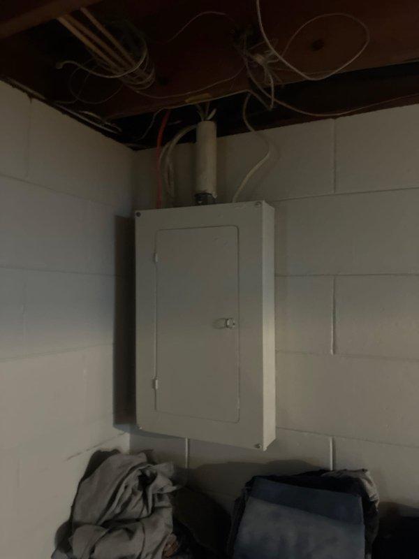 Customer visited office to schedule comfort advisor appointment for evaluation of existing furnace and air conditioning system for potential full replacement, with installation contingent upon financing approval. Site photos documented existing electrical panel, basement utility area, and current HVAC infrastructure including ductwork and piping configuration to assess replacement requirements.
