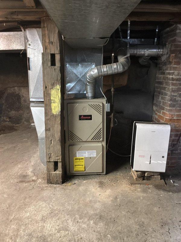 Provided estimate for replacement of aging furnace and air conditioning system located in basement. Current air conditioning unit is non-operational while existing furnace remains functional. Assessed basement installation area including existing Amana furnace, ductwork configuration, and available space for new equipment placement.