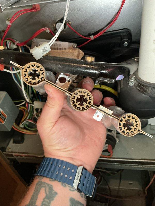 Completed AHM spot check on HVAC system. Inspected thermal limit switch assembly and removed component for examination, revealing three-disc thermal fuse configuration with star-pattern cutouts. Evaluated condensate drain connections and PVC piping, noting accumulated debris and dust on drain line and rubber coupling secured with hose clamp. Assessed system components and documented conditions with photos for maintenance records.