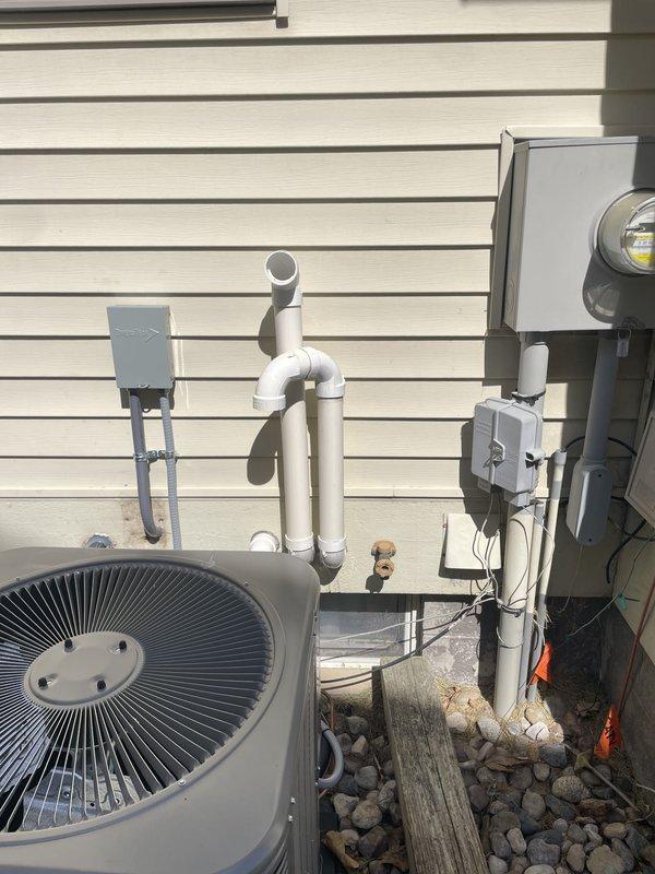 Completed mechanical installation of 2.5 ton air conditioning system with coil in left side yard location. Installed new outdoor condenser unit on concrete pad, established proper drainage with PVC piping system, and mounted electrical disconnect box with reconnection of power supply. Replaced communicating thermostat and integrated RDS into the system to address possible recall issue, ensuring proper communication between components and optimal system operation.