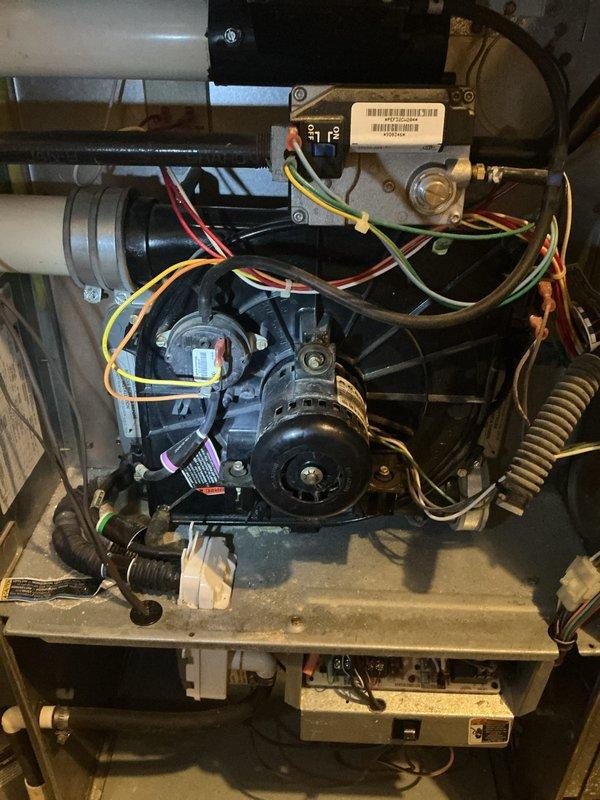 Completed annual HVAC maintenance inspection on air handling unit. Performed thorough examination of blower motor assembly, electrical connections, and internal components including circuit board, wiring harnesses, and gas valve connections. Inspected condensate drain pan and PVC drain line for proper operation, verified all mechanical components are functioning within normal parameters, and documented equipment condition with no immediate service needs identified.