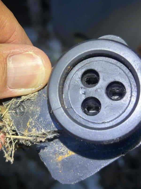 Responded to service call for air conditioning unit repeatedly tripping breaker every four days. Upon inspection, discovered significant debris and insulation fiber buildup in drain system components. Removed and cleaned clogged drain assembly, clearing yellow insulation fibers and accumulated dirt from ports and passages. Verified proper drainage flow, inspected condenser unit exterior condition, and tested system operation. Unit running properly at time of departure with breaker reset and holding under normal load.