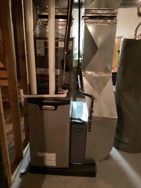 Completed full HVAC system installation including a 70,000 BTU furnace with evaporator coil in basement mechanical room and 2.5-ton air conditioning condenser unit positioned on exterior concrete pad with left-side configuration. Installed new ductwork connections, PVC condensate drainage lines, and refrigerant line set through exterior wall access panel. Coordinated electrical and mechanical permits for furnace installation and 60-amp subpanel integration, with panel upgrade scheduled for completion at later date. All equipment mounted, connected, and tested for proper operation with refrigerant lines professionally routed and insulated between indoor coil and outdoor condenser unit.