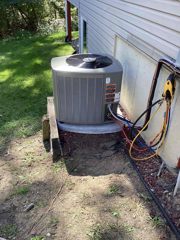 Completed full HVAC system installation including a 70,000 BTU furnace with evaporator coil in basement mechanical room and 2.5-ton air conditioning condenser unit positioned on exterior concrete pad with left-side configuration. Installed new ductwork connections, PVC condensate drainage lines, and refrigerant line set through exterior wall access panel. Coordinated electrical and mechanical permits for furnace installation and 60-amp subpanel integration, with panel upgrade scheduled for completion at later date. All equipment mounted, connected, and tested for proper operation with refrigerant lines professionally routed and insulated between indoor coil and outdoor condenser unit.
