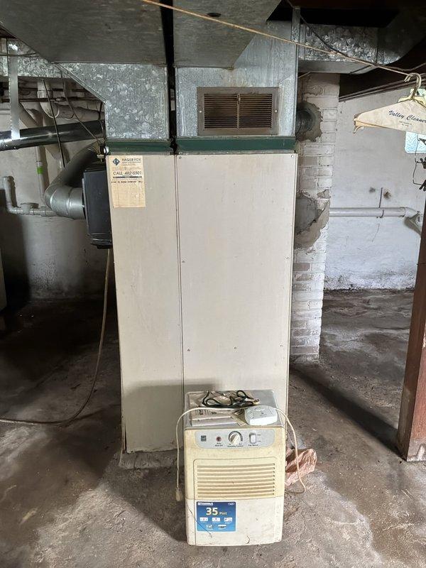 Responded to service call for furnace that would not turn off, affecting whole house heating system. Upon arrival, assessed 46-year-old furnace unit from the 1980s located in basement utility area. Issue began after heat was activated following chimney obstruction from bats. Per customer request, shut off heat to system. Documented existing equipment condition and provided estimate for complete furnace replacement due to age and obsolescence of current unit.