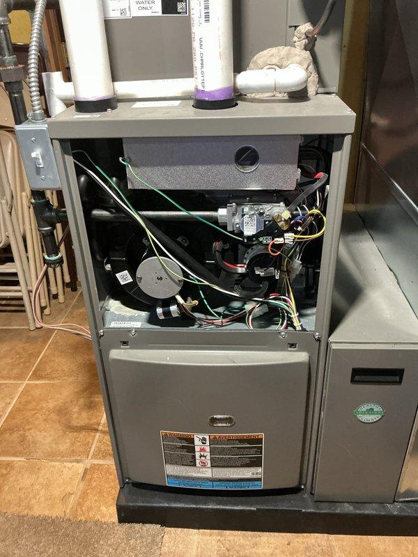 Responded to service call for furnace blowing cool air in basement location. Upon inspection, accessed internal components and identified issue with ignition system preventing proper heating cycle. Replaced faulty ignitor assembly and tested gas valve operation, pressure switches, and electrical connections to ensure proper sequencing. Verified furnace now heating correctly with all safety controls functioning as designed, restored unit to normal operation with parts and labor covered under warranty.