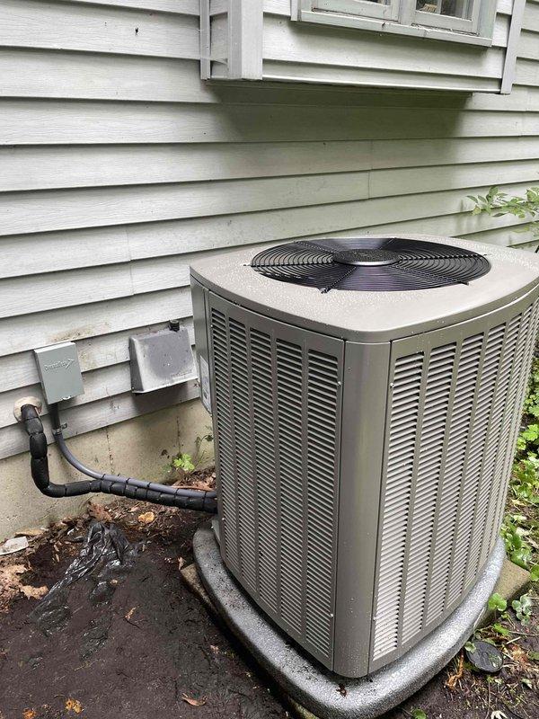 Completed full HVAC system installation including 110,000 BTU furnace and 3.5 ton air conditioning unit with evaporator coil. Installed furnace in basement utility area with proper ductwork connections, PVC condensate drainage system, and electrical conduit routing. Positioned outdoor condensing unit on concrete pad with refrigerant line set connection to exterior wall, completed electrical hookup through junction box, and verified all system components operational. All equipment properly secured, permits obtained, and installation meets mechanical code requirements.