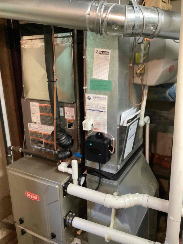 Completed full installation of new air conditioning system and evaporator coil in residential mechanical room. Installed Luxaire air handler unit with associated ductwork connections, PVC condensate drainage lines, and electrical controls including Bryant control box. Connected and secured all refrigerant lines, verified proper airflow through existing ductwork, and established condensate drain routing through white PVC piping system. Reconnected outdoor condenser unit in yard and completed all mechanical connections. Installation performed under mechanical permit for AC tonnage replacement. All equipment tested and operational upon completion, with payment processed via credit card.