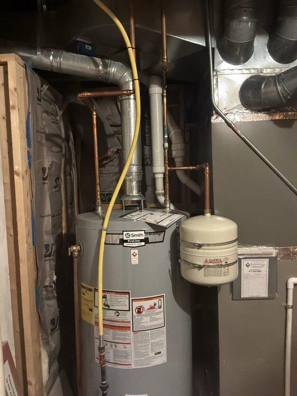 Completed on-site evaluation of 18+ year old natural gas furnace located in basement mechanical room. Unit currently operational but assessed for replacement estimate due to age and efficiency considerations. Documented existing equipment configuration including gas supply lines, venting system, ductwork connections, and surrounding plumbing infrastructure to determine replacement specifications and installation requirements.