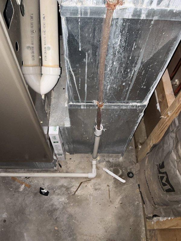 Completed on-site evaluation of 18+ year old natural gas furnace located in basement mechanical room. Unit currently operational but assessed for replacement estimate due to age and efficiency considerations. Documented existing equipment configuration including gas supply lines, venting system, ductwork connections, and surrounding plumbing infrastructure to determine replacement specifications and installation requirements.