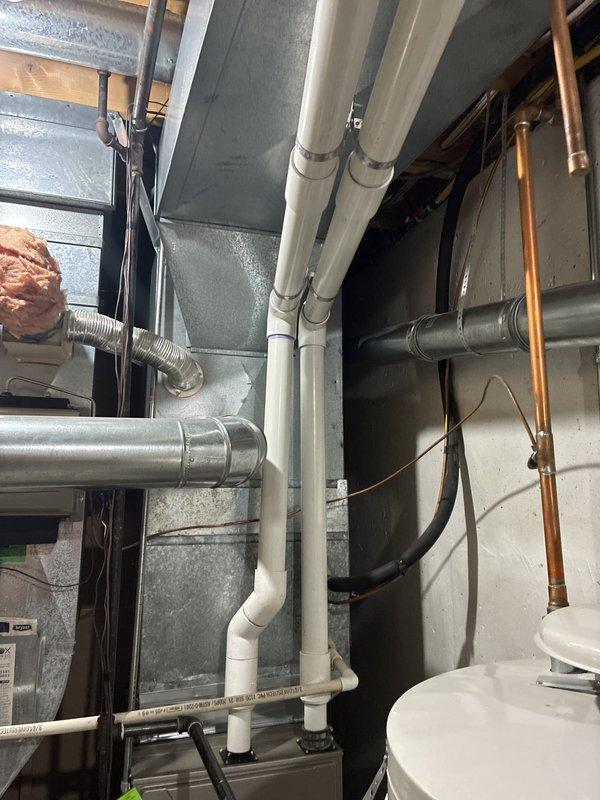 Conducted comprehensive assessment of non-operational 14-year-old RUUD Weather King outdoor condensing unit for complete system replacement estimate. Evaluated existing exterior unit placement, electrical service connections including meter configuration and grounding, condensate drainage routing via PVC piping, and associated indoor mechanical components including basement ductwork, refrigerant line sets, and HVAC infrastructure. Documented current system configuration through photographic records to provide accurate replacement specifications and equipment sizing recommendations for aged air conditioning system.