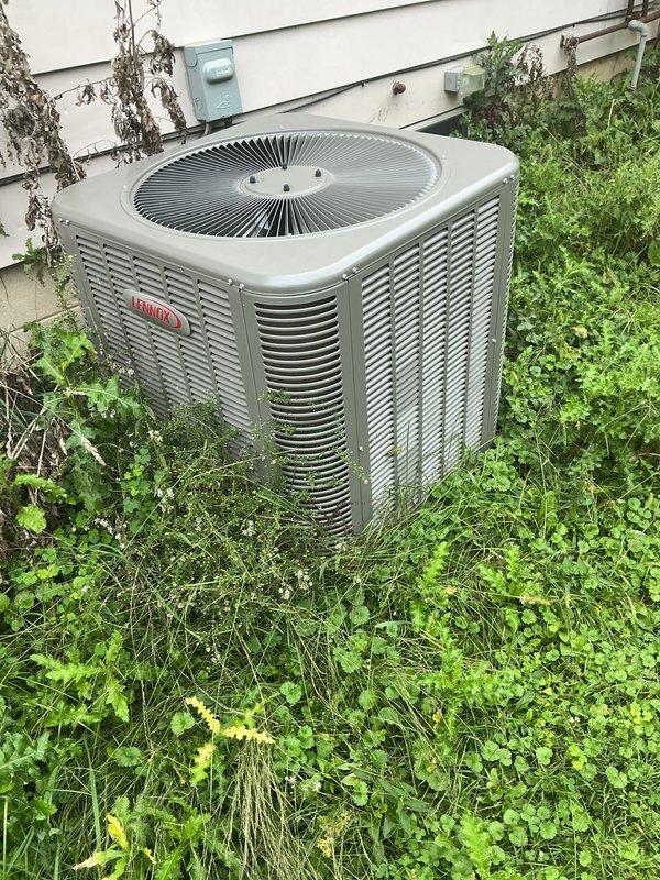 Completed comprehensive AC tune-up on Lennox outdoor condenser unit as part of Air Care membership preventive maintenance. Performed full system inspection, cleaned condenser coils, checked refrigerant levels, tested electrical connections, and verified proper airflow through louvers and fan assembly. Noted significant vegetation growth around unit base and recommended improved clearance for optimal efficiency, though system is operating within normal parameters with no immediate issues requiring repair.