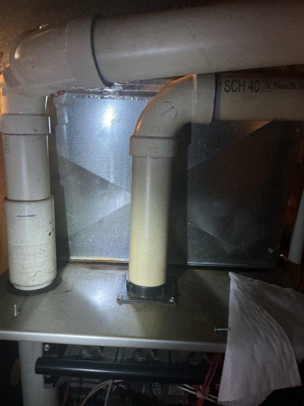 Completed annual heating maintenance on residential HVAC system. Inspected and photographed air filter showing moderate dust accumulation on pleated media within metal frame, indicating normal operation since last service. Examined furnace components including heat exchanger, blower assembly, and PVC condensate drainage system with SCH 40 piping; verified proper installation and sealing of ductwork connections with all components operating within normal parameters.