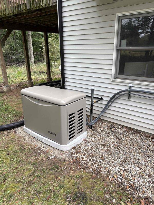 Completed installation of Kohler 26RCA standby generator unit on gravel pad with exterior conduit routing to main electrical service. Installed Siemens RXT-JFNC-200ASE automatic transfer switch in existing electrical panel with proper circuit integration and bolt-on breaker configuration. Coordinated utility power disconnect and reconnection for safe installation, with all work performed under permit and prepared for municipal inspection.