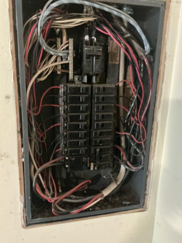 Conducted site assessment for electric vehicle charging station installation at residential property. Evaluated existing electrical infrastructure, including main breaker panel capacity and available circuits, to determine feasibility of EV charger installation. Inspected kitchen area where electric range is located to assess current electrical load and verified panel configuration with multiple existing circuits. Photographed electrical panel showing current wiring arrangement and available breaker spaces for potential dedicated EV charging circuit. Confirmed homeowner currently owns electric vehicle requiring charging capability. Provided comprehensive estimate for installation of Level 2 EV charging station, including required electrical upgrades, dedicated circuit installation, and proper grounding requirements to meet current electrical codes.