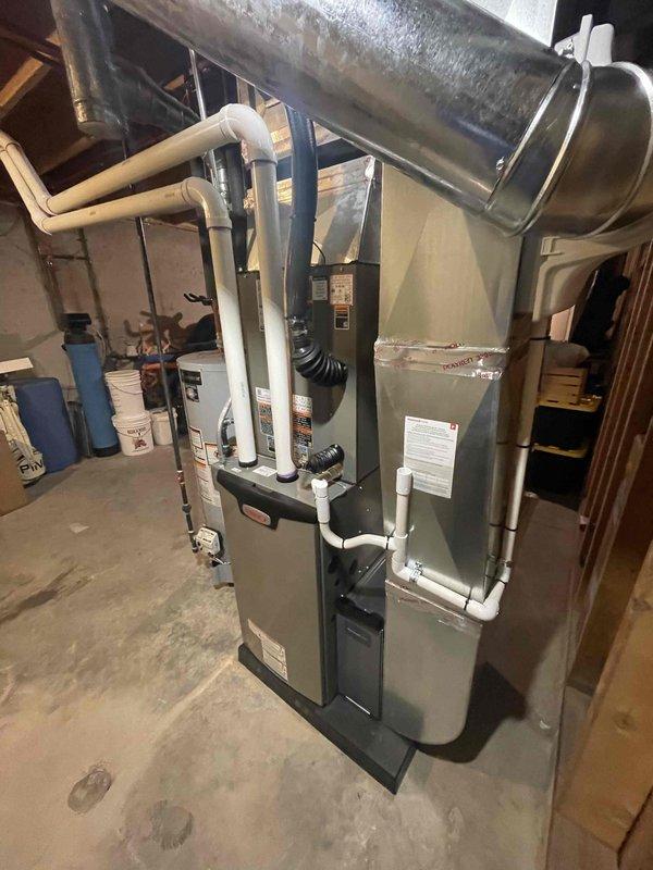 Completed full HVAC system installation including a 70,000 BTU furnace, 3-ton air conditioning unit with matching evaporator coil, and humidifier. The outdoor condensing unit was positioned on a concrete pad in the right side yard with proper electrical disconnect and conduit installation. Inside the mechanical room, installed the new furnace on the concrete floor with all required PVC venting routed through existing ductwork pathways, connected supply and return ductwork using proper transitions and flexible connectors, and integrated the humidifier into the system. Reconnected all electrical components, tested system operation to verify proper heating and cooling functionality, and ensured all connections met code requirements per mechanical permit specifications.