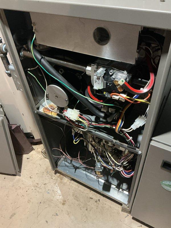 Completed comprehensive winter tune-up and safety inspection on residential gas furnace system. Performed full system diagnostics including burner assembly inspection, heat exchanger examination, blower motor operation verification, and electrical connection testing. All components found operating within manufacturer specifications with no safety concerns identified. Cleaned blower assembly, checked and adjusted gas pressure, verified proper ignition sequence, and tested limit and safety controls. Inspected and documented internal wiring, control board connections, and humidification system components. System demonstrated proper heating operation with adequate airflow and temperature rise across heat exchanger. Recommended continued annual maintenance to ensure optimal performance and longevity of aging equipment.