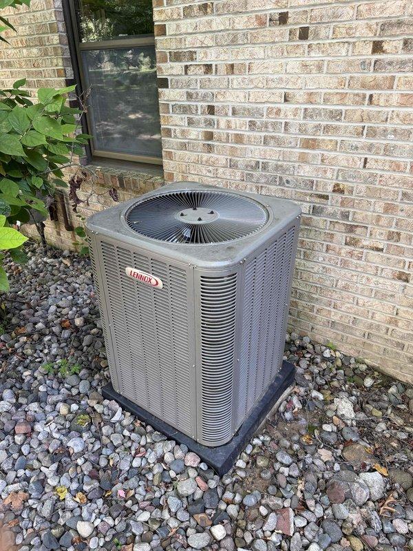 Completed comprehensive AC tune-up and preventative maintenance on residential Lennox outdoor condensing unit. Performed full system inspection, cleaned condenser coils, checked refrigerant levels and pressures, tested electrical connections and capacitor, verified proper airflow through louvers, and confirmed unit operation within manufacturer specifications. System operating efficiently with no issues identified; unit and surrounding area found in good condition.