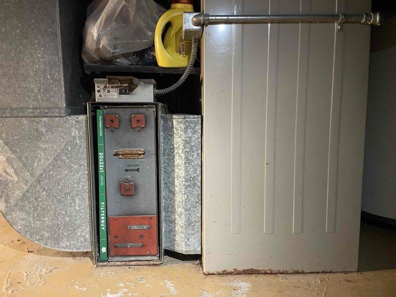 Conducted comprehensive assessment of 51-year-old furnace located in basement utility area accessed via side door. Unit currently operational but has significantly exceeded expected service life. Evaluated existing installation including ductwork configuration, electrical connections, and spatial constraints within confined mechanical room with wood-paneled walls. Documented equipment condition, venting system, and clearance requirements. Prepared replacement estimate for new furnace system accounting for existing infrastructure and access considerations through basement installation.