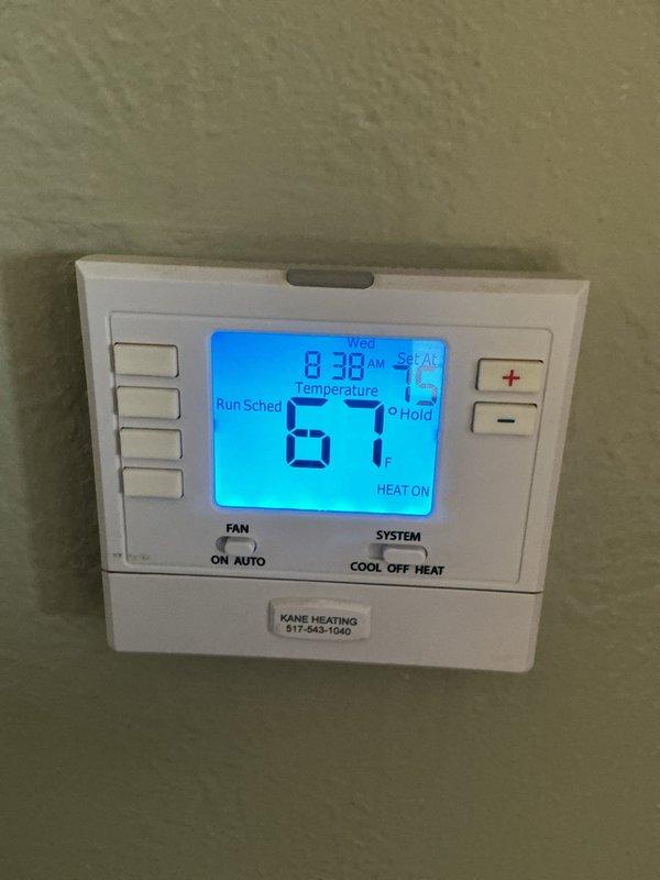 Completed scheduled Air Handler Maintenance (AHM) on heating system. Replaced air filter and evaporator pad as part of routine maintenance protocol. Verified thermostat operation showing system actively heating at 67 degrees. Inspected internal components including gas valve assembly, blower motor, control board, and all electrical connections for proper operation and safety compliance.