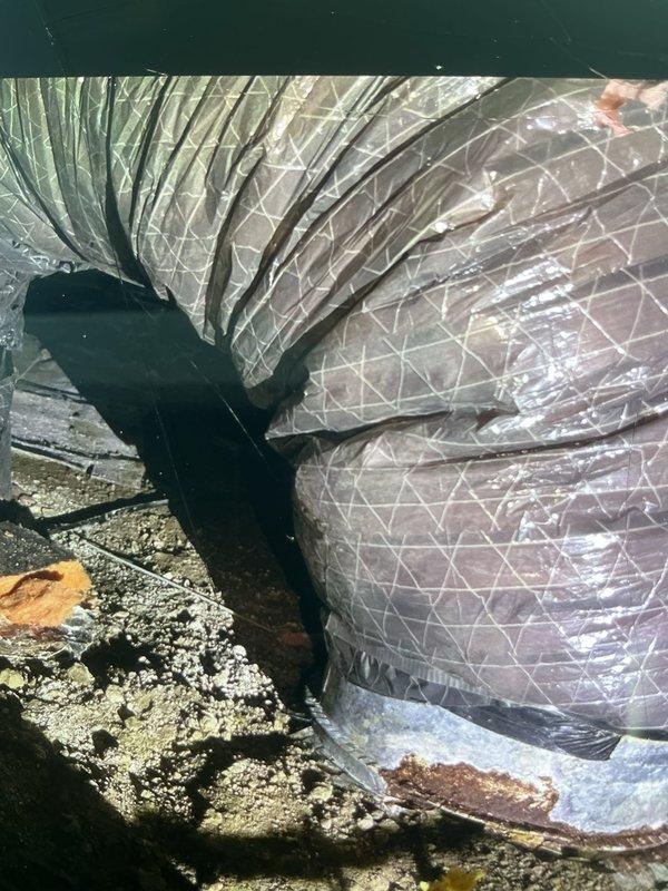 Responded to service call for furnace system damaged by animal intrusion in crawl space. Upon inspection, discovered extensive damage to flexible ductwork and internal furnace components caused by animals chewing through insulation and mechanical parts. Documented severely deteriorated insulation material showing contamination, moisture damage, and compromised integrity within air handler unit. Assessed damaged flexible duct system with compromised insulation wrapper and identified multiple sections requiring replacement. Photographed extent of damage to ductwork and interior components for documentation purposes. Provided customer with assessment of necessary repairs including duct replacement and component restoration to restore system functionality and maintain proper airflow efficiency.