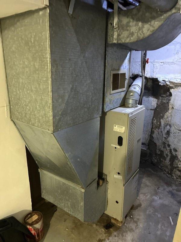 Conducted comprehensive on-site assessment of existing 20-year-old forced air furnace system for full replacement estimate. Inspected current HVAC installation including air handler unit, ductwork connections, refrigerant lines with protective covering, supply and return plenum configurations, and shutoff valve accessibility. Evaluated existing infrastructure condition, clearance requirements, and determined replacement equipment specifications suitable for the space. Documented system configuration and measurements through photographic documentation of mechanical room layout, galvanized ductwork connections, and current equipment positioning to prepare accurate replacement proposal for homeowner.