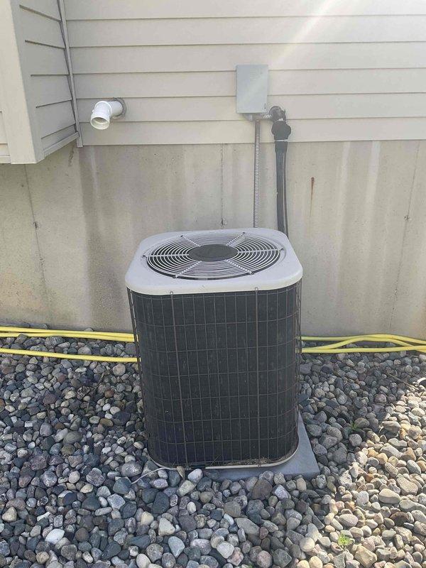Conducted on-site evaluation for complete HVAC system replacement at residential property. Assessed existing furnace/air handler unit located in basement utility area and outdoor condensing unit positioned on concrete pad with rock landscaping. Documented current equipment condition, utility connections including electrical conduit, disconnect box, refrigerant lines, and PVC drainage, and ductwork configuration with exposed metal distribution system throughout basement space. Provided comprehensive replacement estimate for immediate system upgrade based on customer's request for prompt installation.