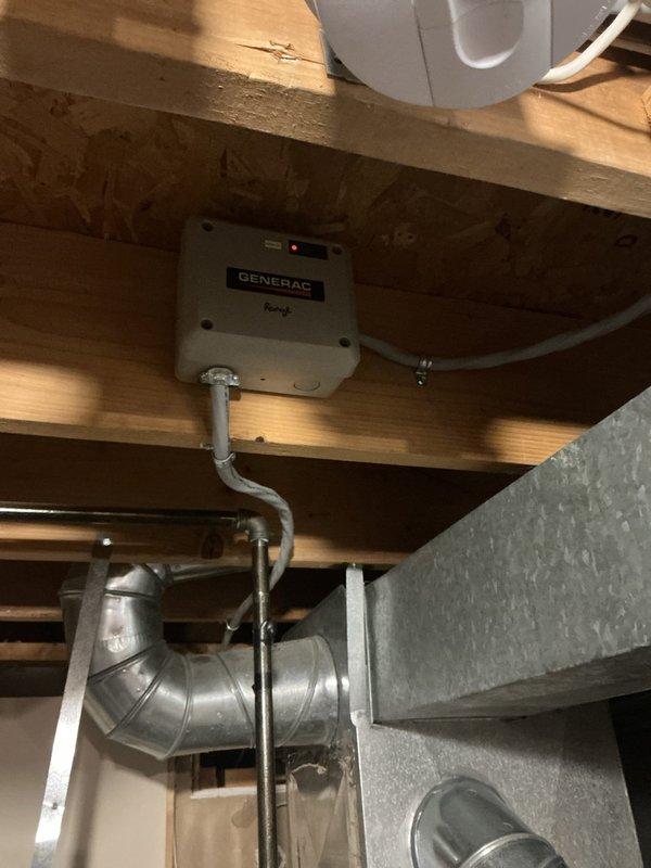 Completed installation of 22kW Generac standby generator with 100-amp automatic transfer switch. Mounted Generac transfer switch in basement ceiling space with proper conduit routing and secured all electrical connections per manufacturer specifications. Installed ceiling access panel for future maintenance access to transfer switch components, ensuring clean integration with existing interior finishes.