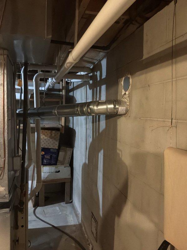 Conducted comprehensive assessment of 25-year-old gas furnace system located in basement mechanical room. Evaluated existing HVAC equipment including furnace unit, air handler, ductwork distribution network, and associated piping infrastructure. Documented current system configuration with detailed photography showing beige furnace unit with manufacturer specifications, metal supply and return ductwork, copper refrigerant lines, and concrete block wall mounting. Assessed condition of horizontal and vertical duct runs, insulated supply plenum, and electrical connections. Provided replacement recommendations and equipment options suitable for residential heating requirements.