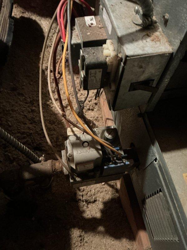 Completed annual HVAC maintenance on heating system located in attic space. Performed comprehensive inspection of blower motor assembly, gas valve controls, and electrical connections. Replaced air filters per SPOTS protocol and verified all wiring connections were secure with proper color coding intact. Inspected transformer unit and control assemblies for proper operation, noting age-related dust accumulation throughout system components.