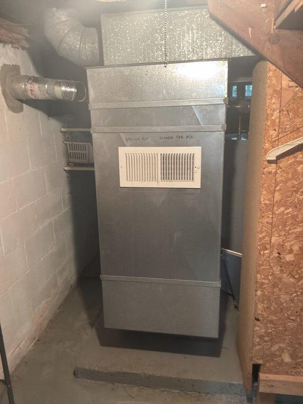 Completed full system HVAC estimate for 20-year-old furnace and air conditioning system replacement under BOGO promotion. Documented existing equipment configuration including air handler unit with return air vent, ductwork connections, and overall system condition in basement mechanical room to provide comprehensive replacement proposal.