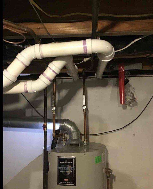 Provided estimate for replacement of non-functional 50-gallon natural gas water heater with new 55-gallon unit. Assessed existing Bradford White water heater installation, including copper supply lines, gas piping with shutoff valve, and metal vent pipe connected to chimney flue. Quoted complete installation service including removal and haul-away of existing unit, with customer requesting to add project to existing financing plan.