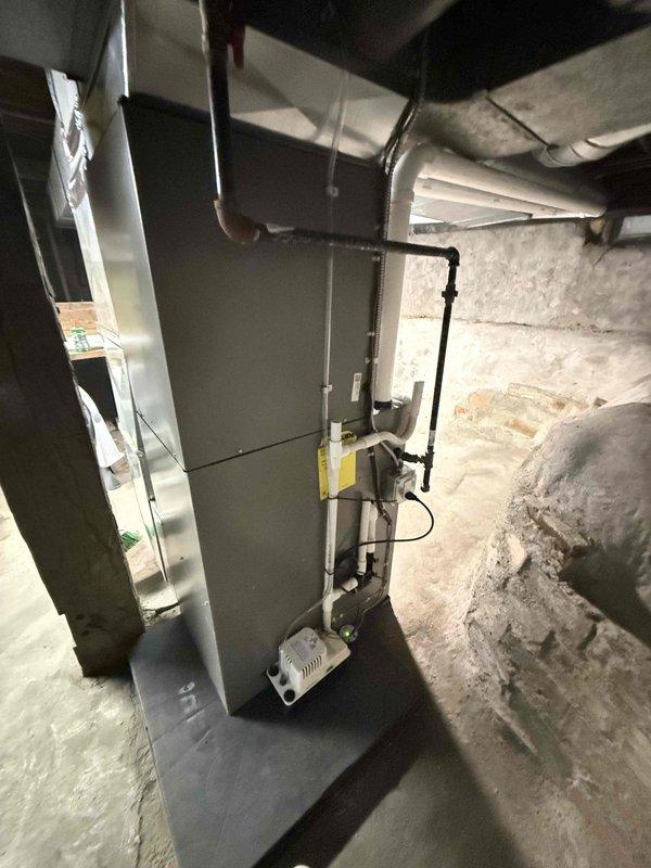 Completed full HVAC system installation including a 70,000 BTU gas furnace and 2.5-ton air conditioning unit. Furnace was installed in basement utility room with proper venting, ductwork connections, and humidifier integration. AC condenser unit was positioned on concrete pad in left side yard with refrigerant lines and electrical connections completed. All mechanical permits were requested and system reconnection was performed to ensure proper operation of both heating and cooling components.
