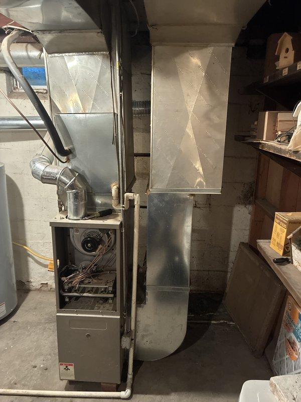 Conducted comprehensive assessment of 24-year-old natural gas furnace and air conditioning system located in basement mechanical room. Current equipment remains operational but experienced performance issues during previous cooling season with limited parts availability due to age of units. Evaluated existing HVAC configuration including furnace with blower assembly, ductwork plenum system, and associated components to provide replacement equipment recommendations for both heating and cooling systems.