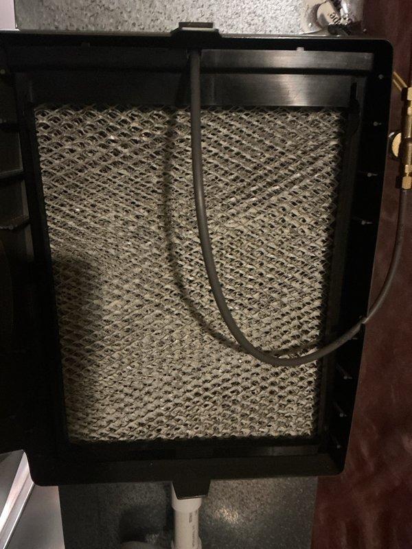 Completed annual heating maintenance on residential HVAC system. Inspected air filter housing and found filter with moderate dust accumulation and discoloration, indicating normal usage since last service. Examined internal furnace components including blower assembly, electrical connections, and control wiring—all found to be intact and operational. Noted age-related dust buildup on interior surfaces but no signs of component failure, corrosion, or safety concerns. System tested and confirmed ready for heating season.