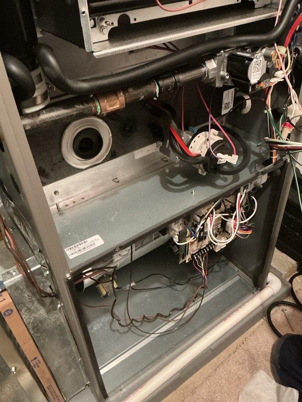 Completed annual heating maintenance on residential HVAC system. Inspected air filter housing and found filter with moderate dust accumulation and discoloration, indicating normal usage since last service. Examined internal furnace components including blower assembly, electrical connections, and control wiring—all found to be intact and operational. Noted age-related dust buildup on interior surfaces but no signs of component failure, corrosion, or safety concerns. System tested and confirmed ready for heating season.