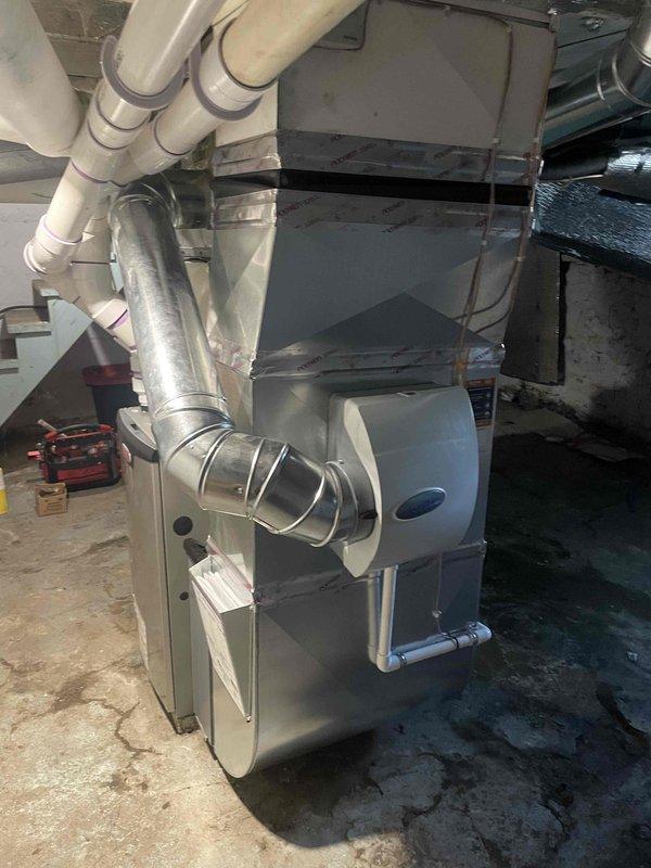 Completed installation of Bryant 90,000 BTU high-efficiency furnace in residential basement utility room. Installed new PVC venting system, connected humidifier unit, and reconnected existing ductwork including supply and return plenums with insulated trunk lines. All electrical and gas connections completed per code requirements and manufacturer specifications.