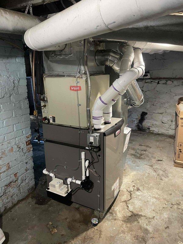 Completed installation of Bryant 90,000 BTU high-efficiency furnace in residential basement utility room. Installed new PVC venting system, connected humidifier unit, and reconnected existing ductwork including supply and return plenums with insulated trunk lines. All electrical and gas connections completed per code requirements and manufacturer specifications.
