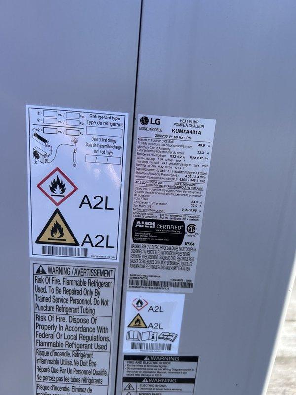 Responded to service call for LG mini split heat pump system (model KUMA4481A) displaying error code 228 indicating refrigerant leak malfunction. Accessed rooftop installation where multiple outdoor condenser units are mounted on elevated frame supports. Performed diagnostic evaluation of the affected LG unit, documented equipment nameplate data showing A2L refrigerant type, and captured photographic evidence of the installation and equipment condition for further assessment and repair recommendations.