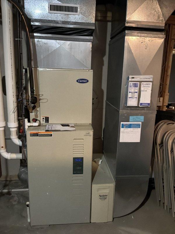 Conducted comprehensive evaluation of existing HVAC system for full replacement estimate. Assessed 25-year-old Carrier furnace located in basement and 25-year-old air conditioning unit positioned outside, both units having reached end of serviceable life expectancy. Documented current equipment specifications, configuration, and installation conditions through detailed photography of furnace, air handler, ductwork connections, refrigerant line routing, condensate drainage system, and mechanical room layout. Evaluated electrical connections, venting systems including white PVC exhaust pipes, and existing ductwork infrastructure to determine compatibility requirements for new equipment installation. Provided homeowner with replacement options and system sizing recommendations for single-family residential application to restore whole-home climate control functionality.