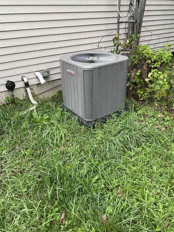 Conducted comprehensive HVAC system replacement estimate for residential property with 16-year-old furnace and outdoor air conditioning condenser unit. Evaluated existing cylindrical AC unit with gray metal casing positioned on side of house, inspected indoor furnace equipment in utility area, and documented current system conditions through photographic assessment. Provided replacement options and recommendations based on equipment age and customer's timeline to complete installation within the next couple of weeks.