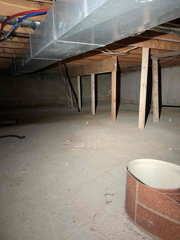 Assessed 30+ year old furnace in basement of 2-story, 2400 sq ft home that had failed and was no longer operational. Evaluated existing dual-furnace system configuration and investigated feasibility of replacing both units with a single high-capacity system to serve entire home. Documented existing equipment location in half basement with poured foundation, photographed current furnace installation and ductwork layout, and provided replacement options and recommendations based on home size and heating requirements.