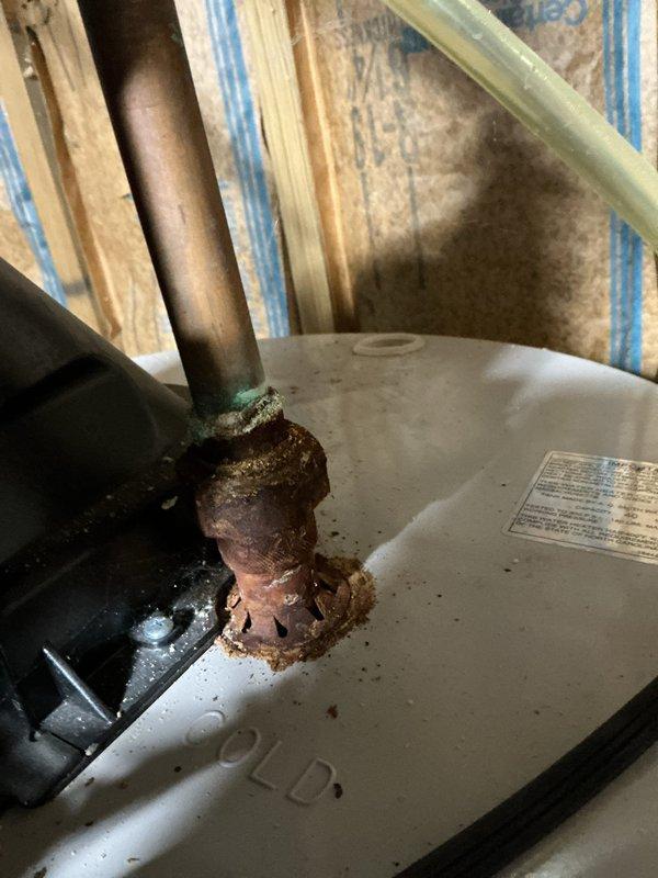 # HVAC Maintenance - ComfortGuard Maintenance Package

Completed comprehensive 5-year recurring maintenance visit on residential HVAC system. Conducted thorough inspection of mechanical systems and associated plumbing components in basement utility area.

## Work Performed

Performed detailed visual inspection of water heater and connected plumbing infrastructure. Documented extensive corrosion on water heater pipe connection at tank entry point, showing significant rust deterioration, pitting, and oxidized material buildup at junction. Noted severely corroded condition requiring immediate attention to prevent potential failure.

Inspected copper supply line network including multiple vertical and horizontal runs with brass fittings and ball valves. Evaluated condition of various pipe sections, noting age variations and patina development. Identified section of copper piping with turquoise corrosion and white mineral deposit accumulation indicating active deterioration process.

Examin
